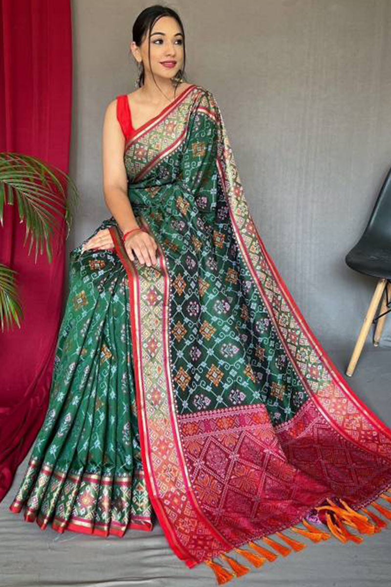 Jazzy Dark Green Patola Silk Saree with Cynosure Blouse Piece
