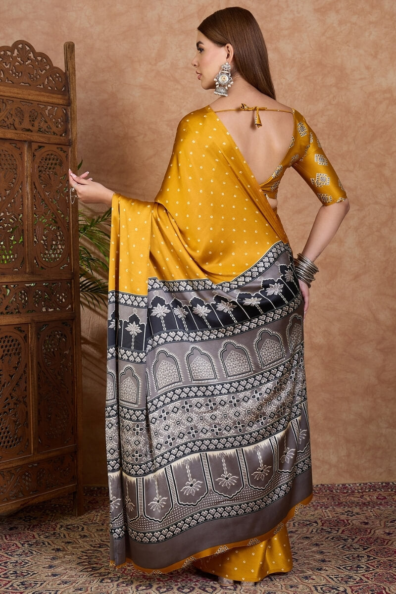 Adorning Mustard Ajrakh Printed Semi Modal Silk Saree With Tantalizing Blouse Piece