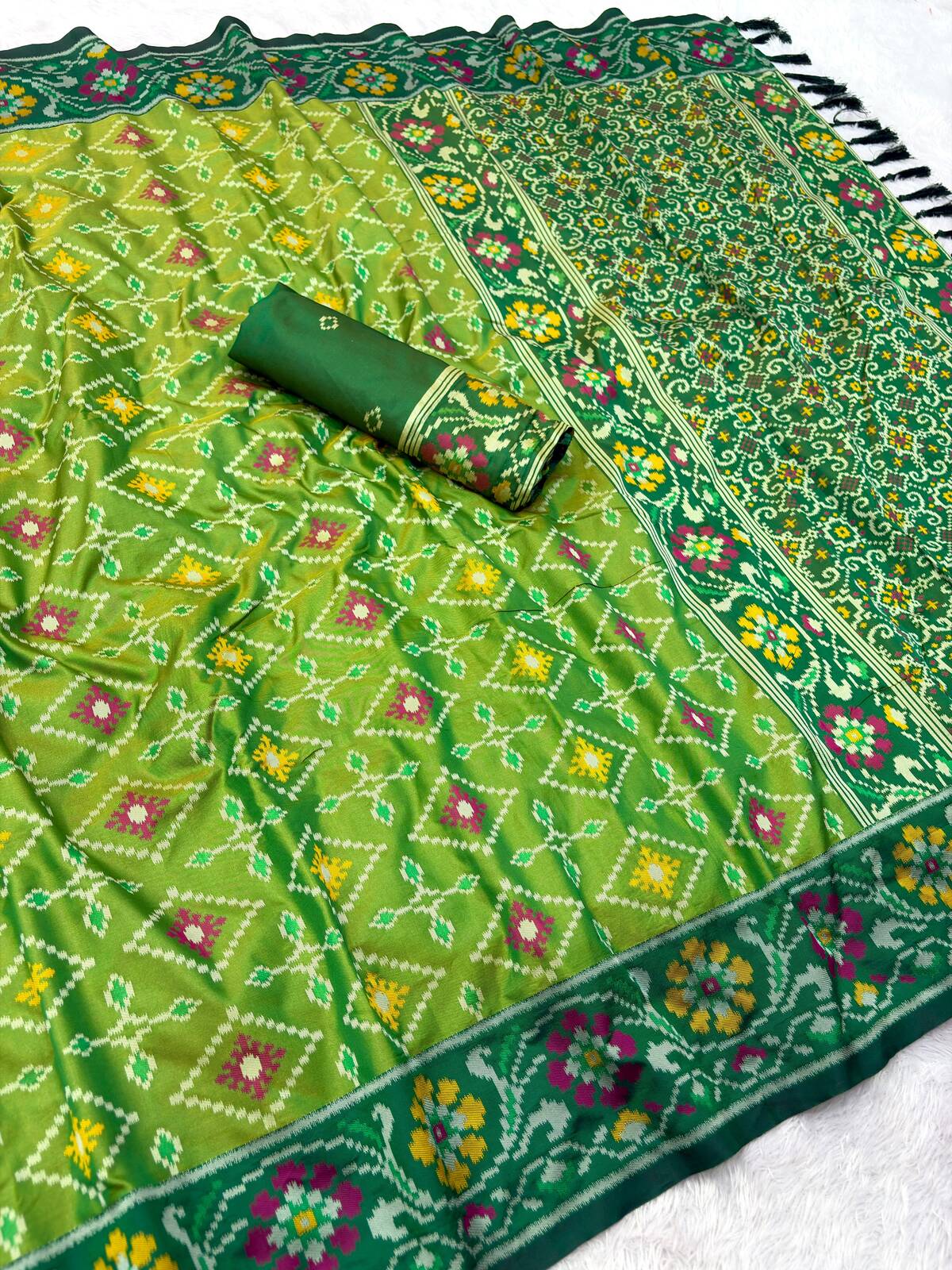 Staring Green Patola Silk Saree with Profuse Blouse Piece
