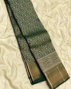 Eloquence Dark Green Soft Banarasi Silk Saree With Engrossing Blouse Piece
