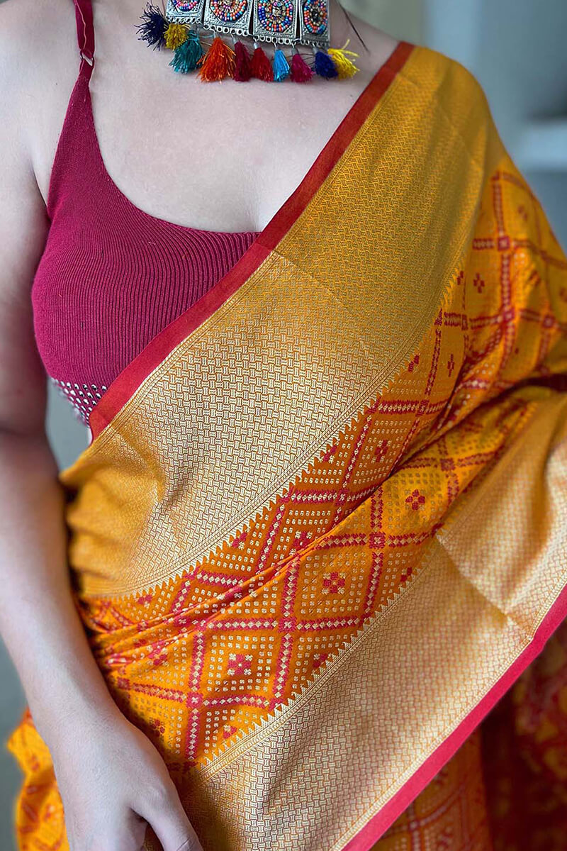 Beauteous Mustard Patola Silk Saree with Delectable Blouse Piece