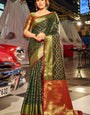 Beauteous Dark Green Patola Silk Saree with Pleasant Blouse Piece