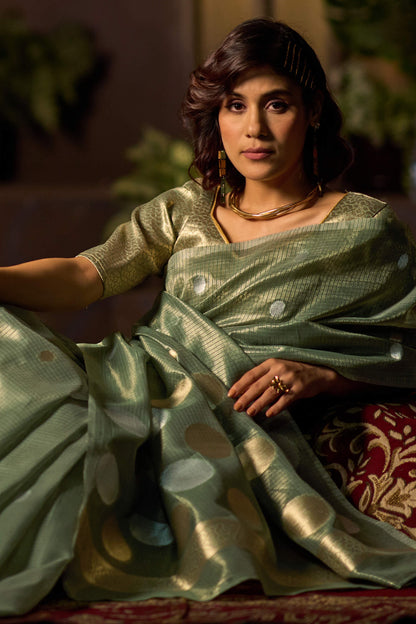 Murmurous Sea Green Soft Banarasi Tissue Silk Saree With Enticing Blouse Piece