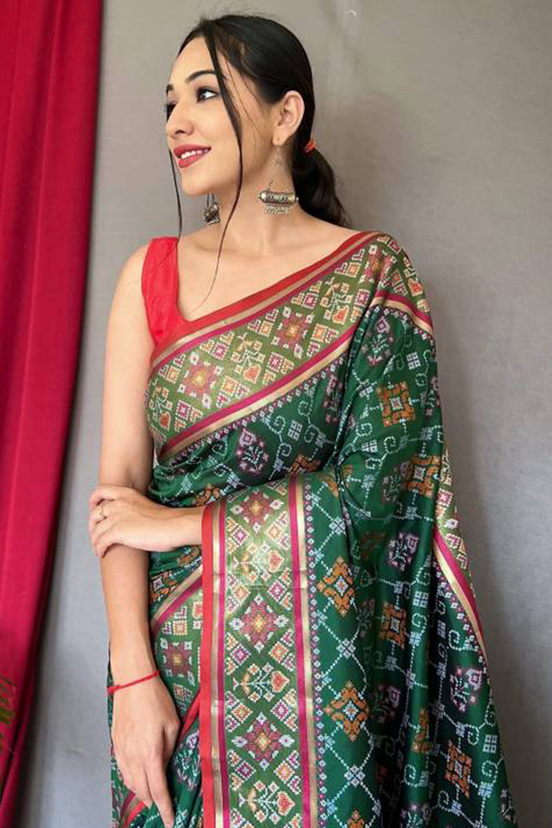 Jazzy Dark Green Patola Silk Saree with Cynosure Blouse Piece