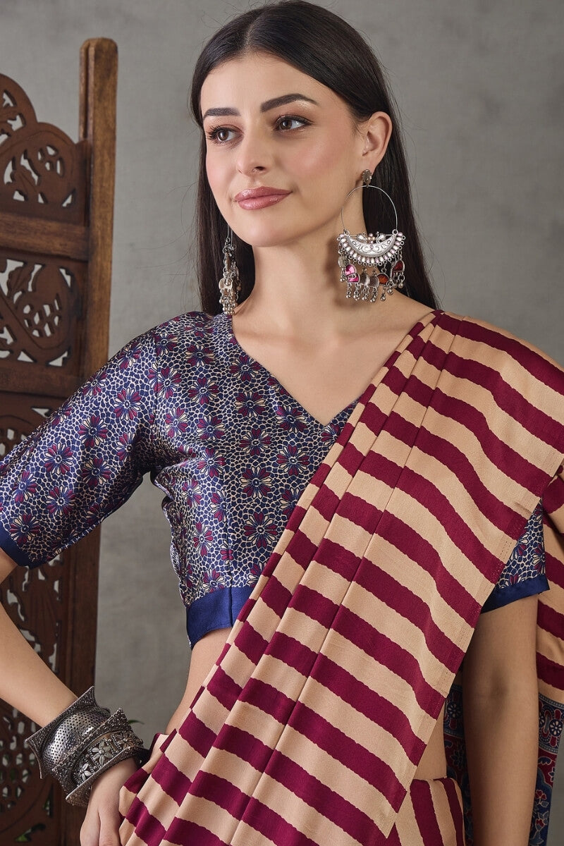 Prominent Maroon Ajrakh Printed Semi Modal Silk Saree With Engaging Blouse Piece