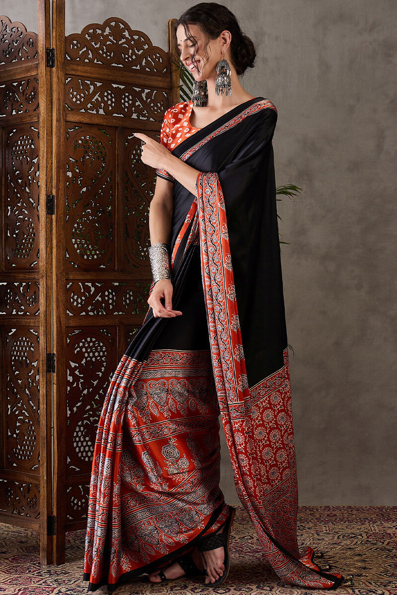 Enticing Black Ajrakh Printed Semi Modal Silk Saree With Winsome Blouse Piece
