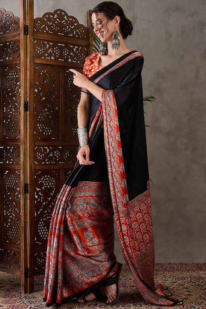 Enticing Black Ajrakh Printed Semi Modal Silk Saree With Winsome Blouse Piece