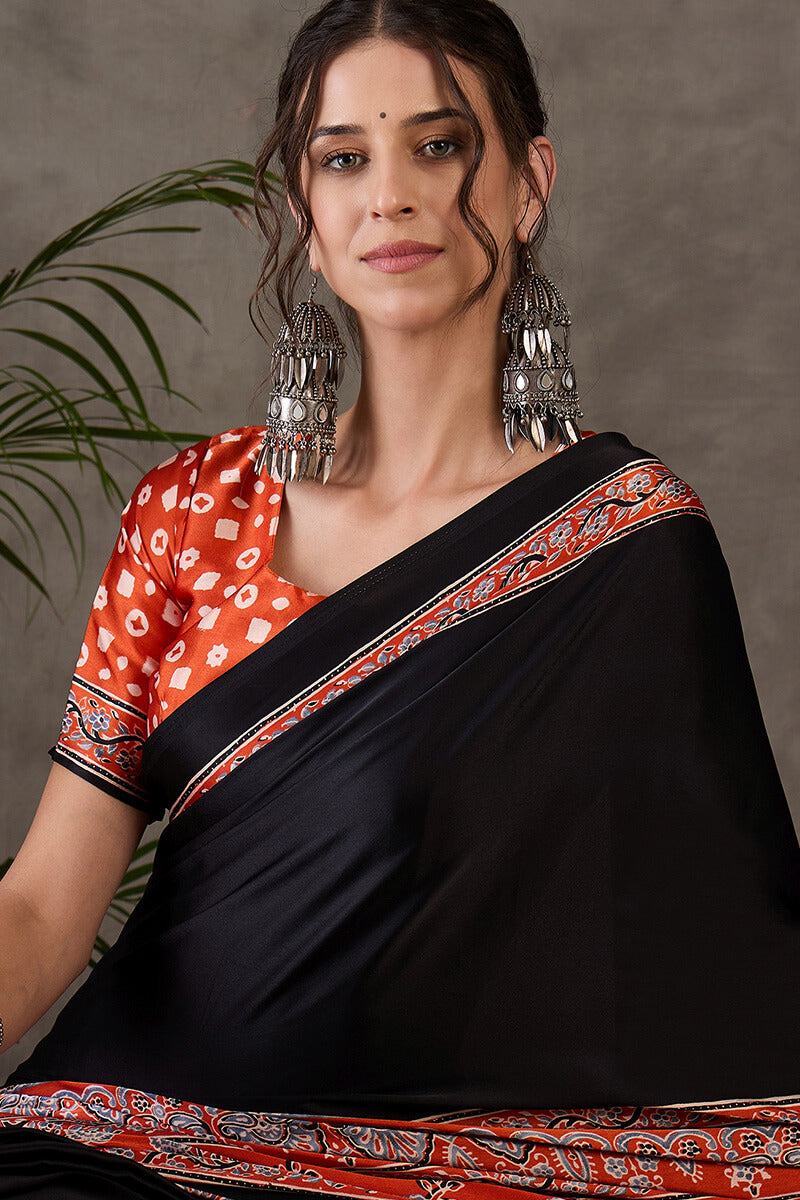 Enticing Black Ajrakh Printed Semi Modal Silk Saree With Winsome Blouse Piece