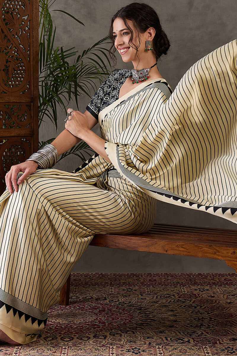 Alluring Beige Ajrakh Printed Semi Modal Silk Saree With Cynosure Blouse Piece