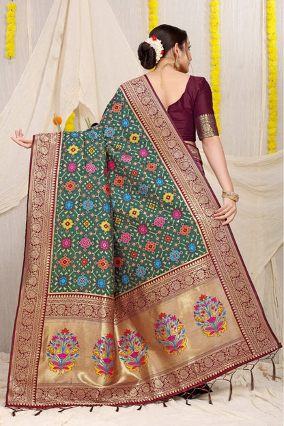 Sophisticated Dark Green Soft Patola Silk Saree with Demanding Blouse Piece