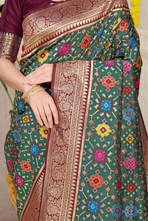 Sophisticated Dark Green Soft Patola Silk Saree with Demanding Blouse Piece
