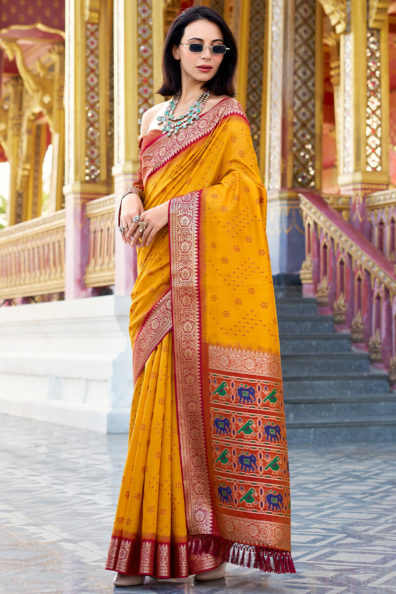 Unequalled Yellow Patola Silk Saree with Enthralling Blouse Piece