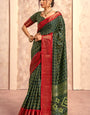 Enigmatic Dark Green Foil Printed Dola Silk Saree With Incomparable Blouse Piece