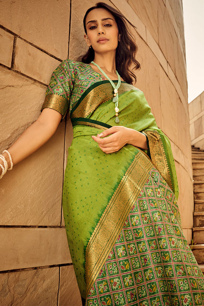 Ornate Green Patola Silk Saree with Tremendous Blouse Piece