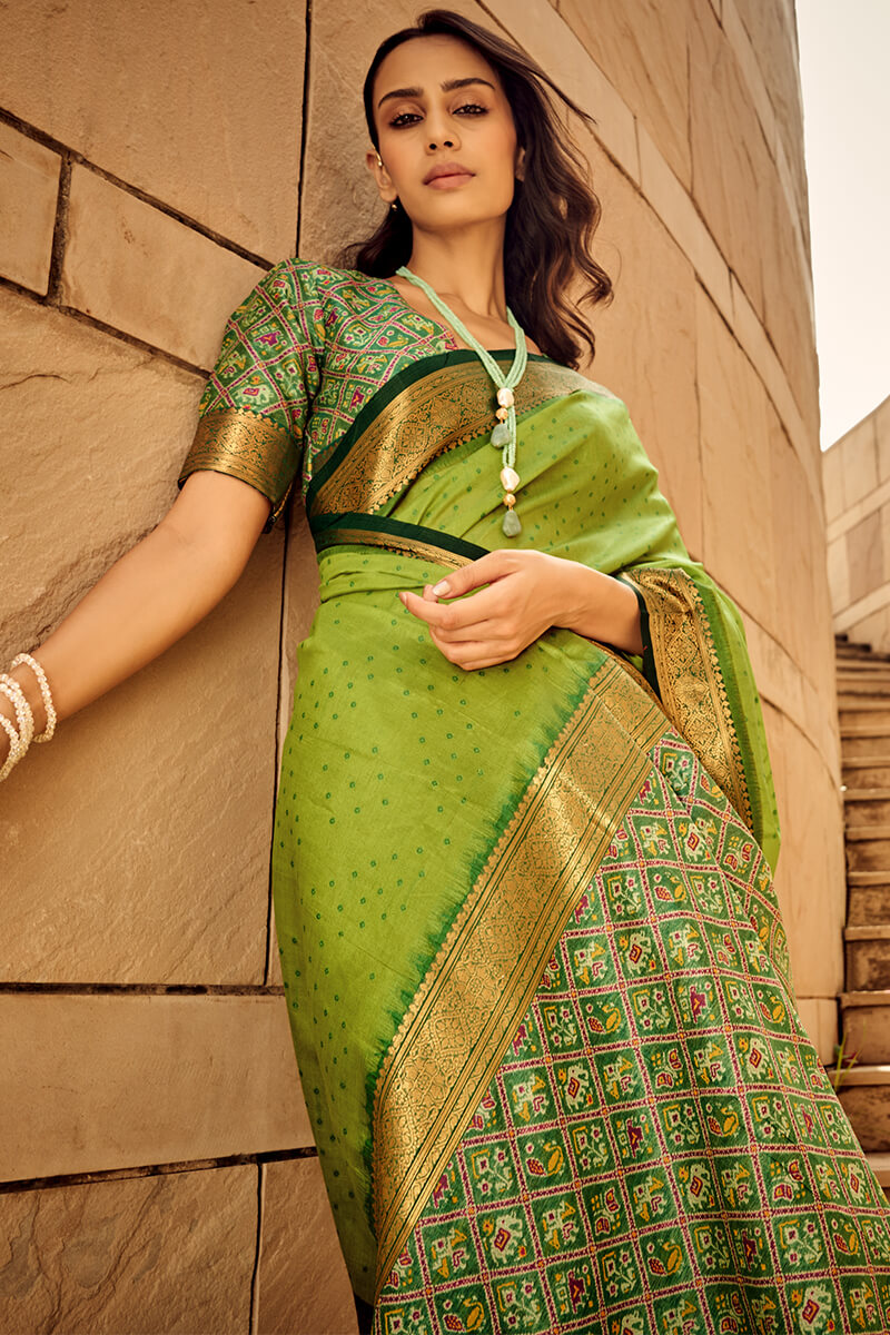 Ornate Green Patola Silk Saree with Tremendous Blouse Piece