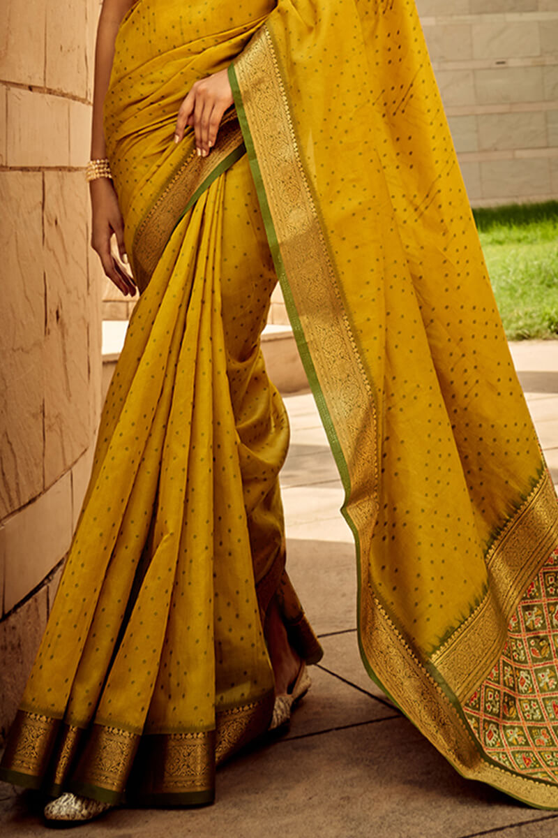 Twirling Mustard Patola Silk Saree with Glorious Blouse Piece