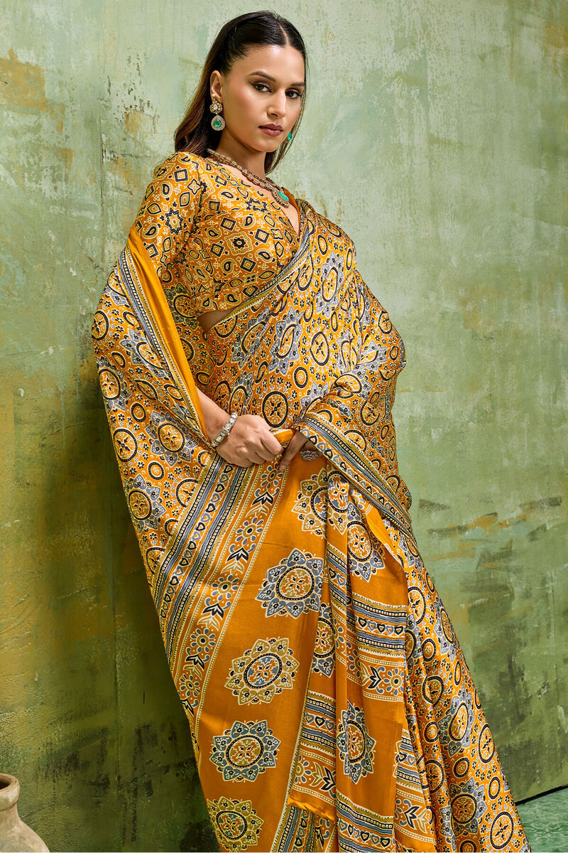 Elegant Mustard Ajrakh Printed Satin Silk Saree With Winsome Blouse Piece