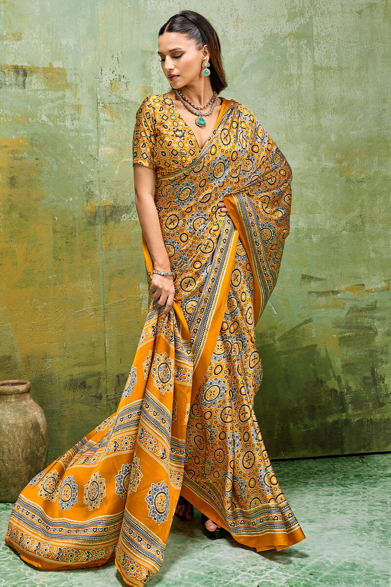 Elegant Mustard Ajrakh Printed Satin Silk Saree With Winsome Blouse Piece