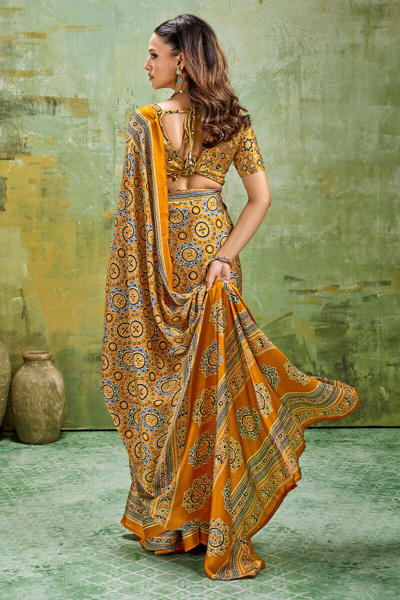 Elegant Mustard Ajrakh Printed Satin Silk Saree With Winsome Blouse Piece