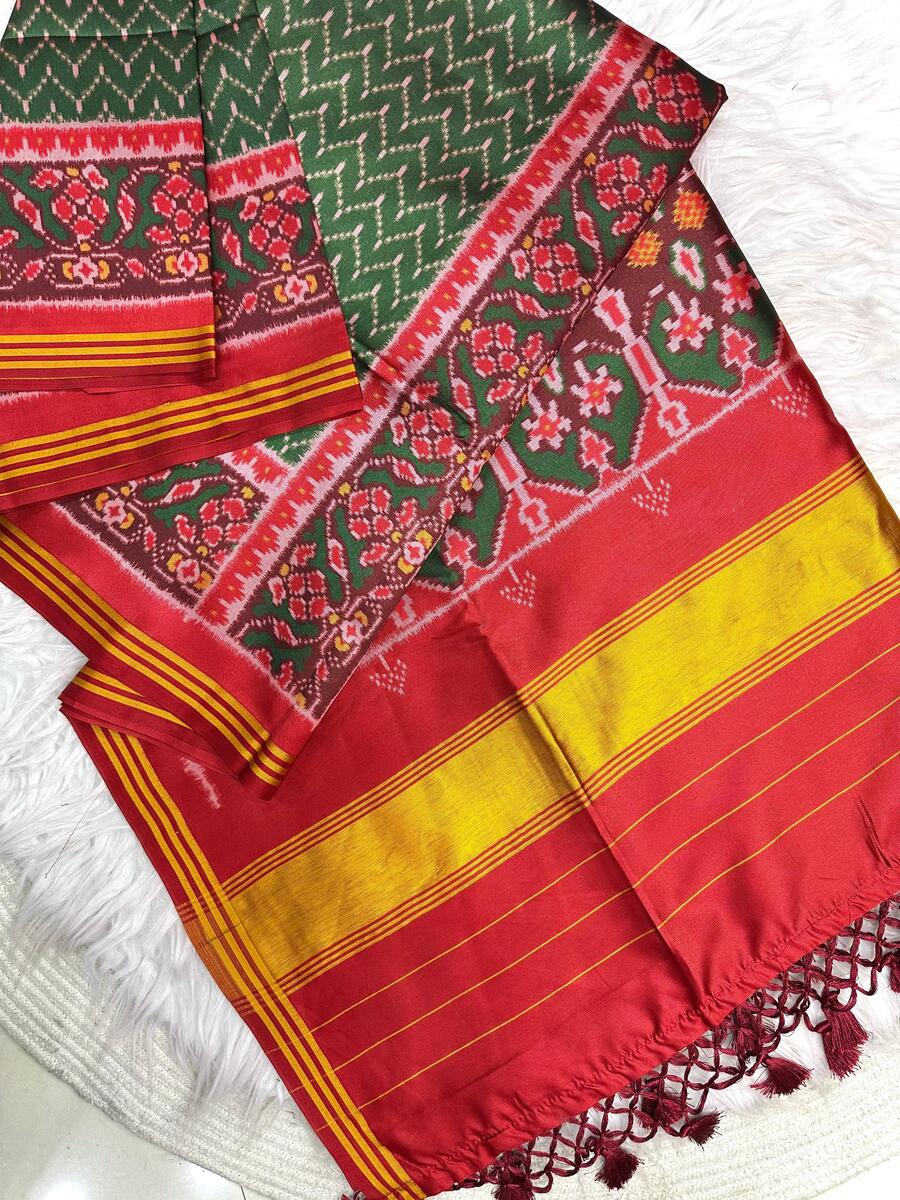 Jubilant Dark Green Ikkat Printed Patola Silk Saree With Entrancing Blouse Piece