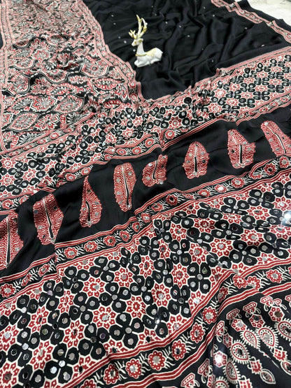 Divine Black Ajrakh Printed Mirror Work Satin Silk Saree With Vibrant Blouse Piece