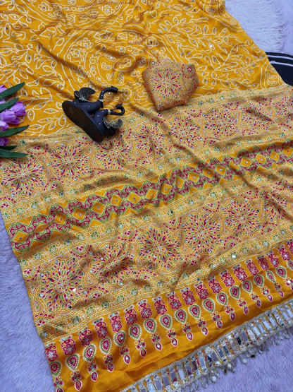 Enticing Yellow Ajrakh Printed Mirror Work Satin Silk Saree With Surreptitious Blouse Piece