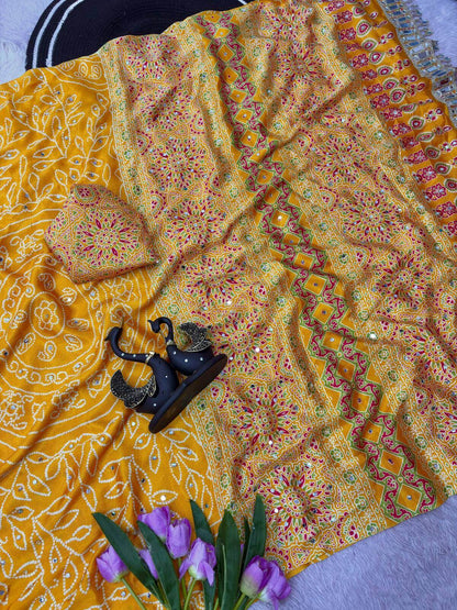 Enticing Yellow Ajrakh Printed Mirror Work Satin Silk Saree With Surreptitious Blouse Piece