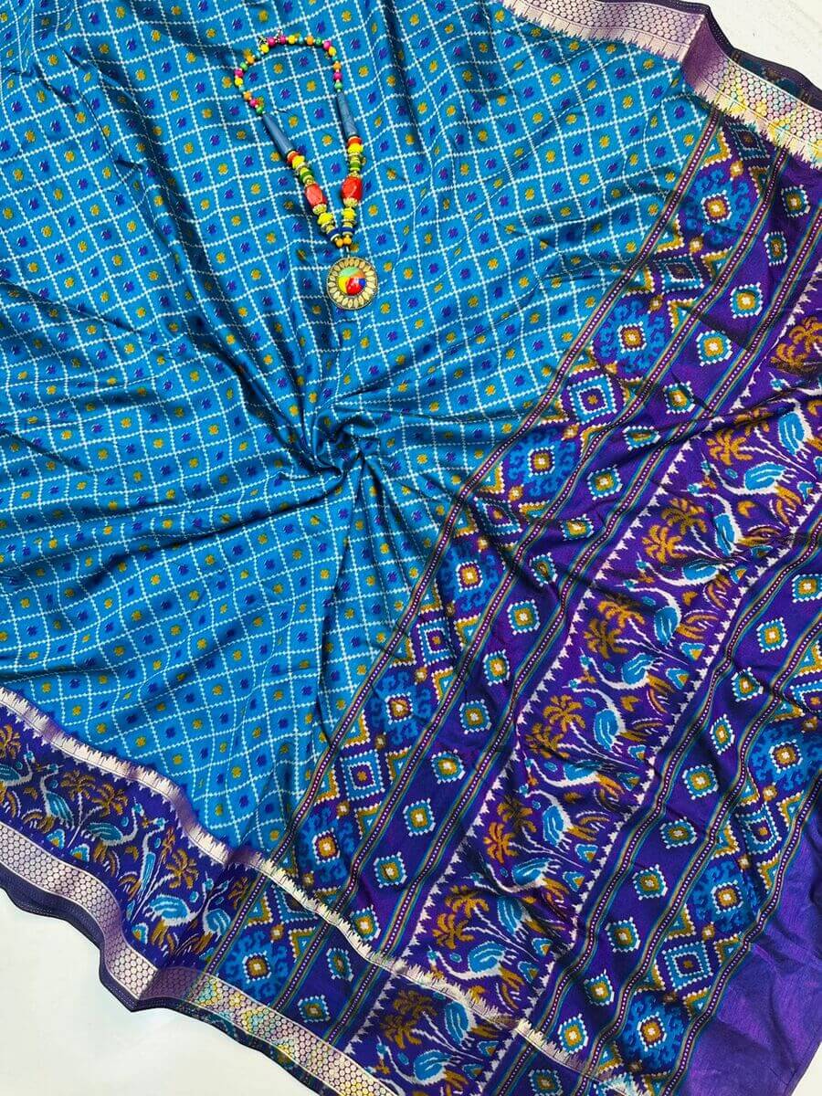 Dalliance Firozi Soft Printed Patola Silk Saree with Tantalizing Blouse Piece