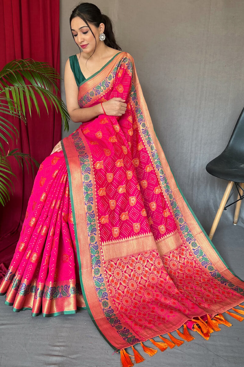 Sophisticated Dark Pink Patola Silk Saree with Capricious Blouse Piece