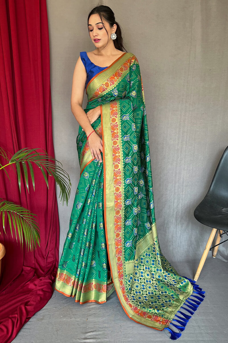 Mesmeric Green Patola Silk Saree with Twirling Blouse Piece