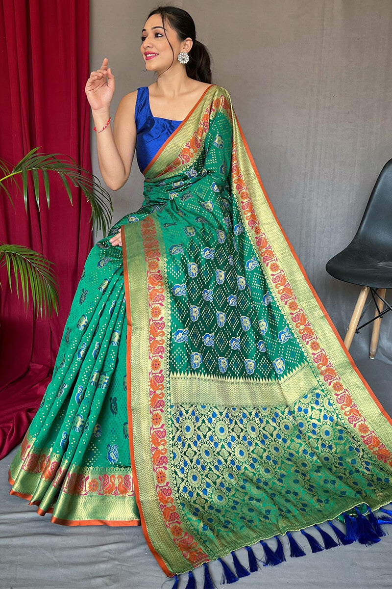 Mesmeric Green Patola Silk Saree with Twirling Blouse Piece