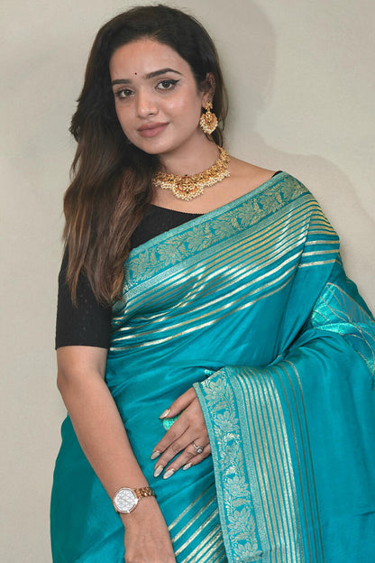 Staring Firozi Soft Banarasi Silk Saree With Jazzy Blouse Piece
