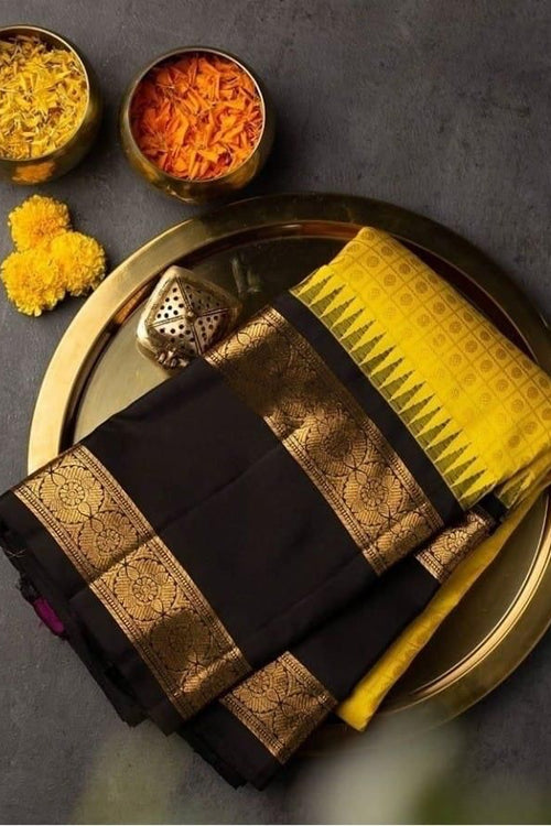 Load image into Gallery viewer, Delectable Yellow Soft Banarasi Silk Saree With Magnetic Black Blouse Piece
