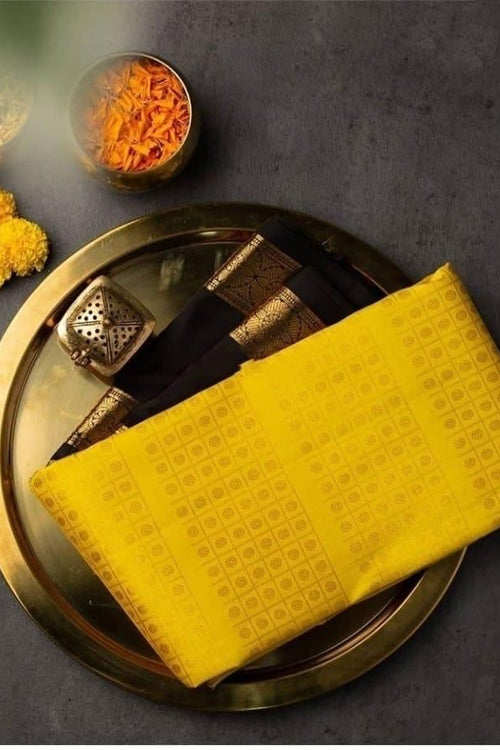 Load image into Gallery viewer, Delectable Yellow Soft Banarasi Silk Saree With Magnetic Black Blouse Piece
